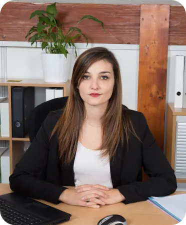 Professional woman in a black blazer sitting at a desk