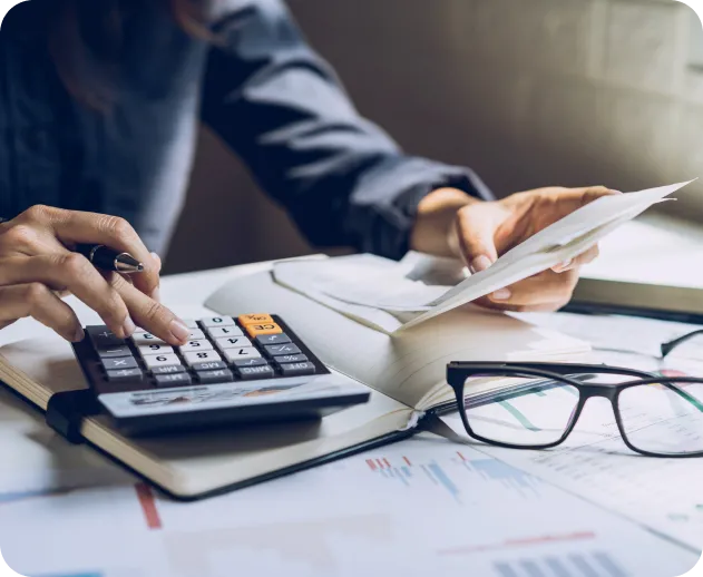 Accountant using a calculator to review financial paperwork